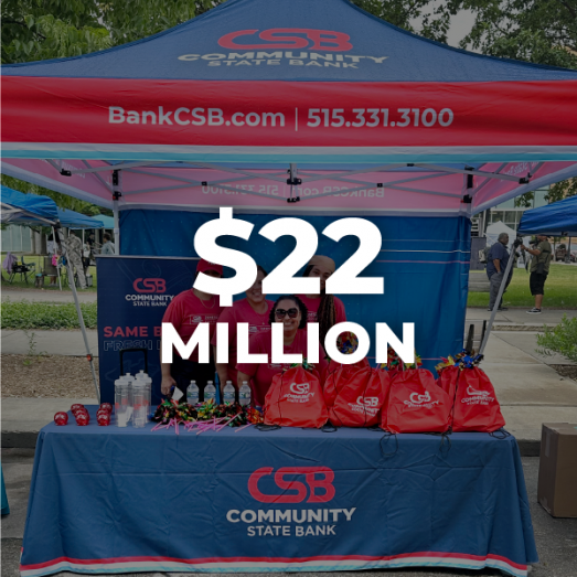 A group of employees wearing matching blue shirts, smiling together at a volunteer event. Text overlayed on image reads twenty two million dollars.