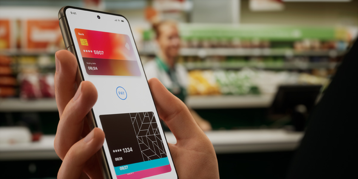 Phone screen with debit cards showing on screen, out of focus shop in background Phone screen with debit cards showing on screen, out of focus shop in background